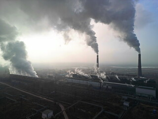 Thermal power plant. Active smoke from pipes and cooling towers. The view from the drone.