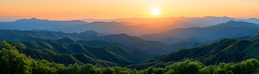 Fototapeta premium Sunset over rolling green mountains.