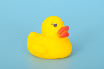 Toy Duck on Blue Background: Minimalist Childhood Concept