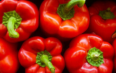 Six Organic Red Peppers stacked on top of each other in a grocery store. 
Located in Marlton, New Jersey Whole Foods Market.