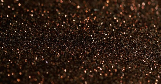 Blur sparkling. Golden glitter. Shimmering festive surface with fine metallic dust. Color precious overflows shining powder particles.