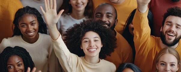 Group of diverse smiling people waving hands and celebrating in a cheerful atmosphere.