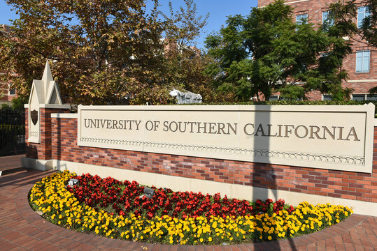 LOS ANGELES, CALIFORNIA - 4 DEC 2024: Sign and flowers at  an Exposition Boulevard entrance to the University of Southern California.