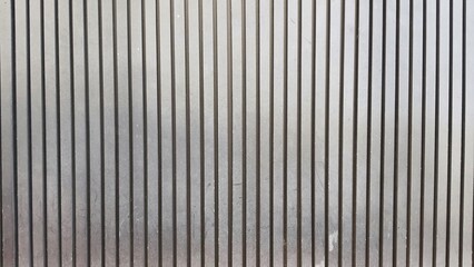 Obraz premium Vertical black and grey wooden wall texture image. Wood slats, wall pattern surface texture. The walls are made of old and damaged wooden boards.