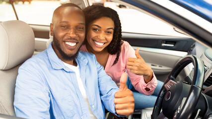 Great Car. Happy African Amercan Couple Showing Thumbs Up Sign Gesture, Sitting In New Automobile...