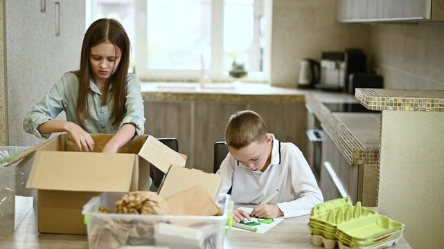 Сhildren paint symbol recycle. Kids sort paper and plastic into sorting bin in the kitchen at home. Waste segregation, waste sorting, waste recycle.