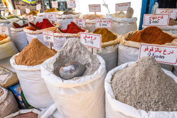 Traditional Arabic stand with spices at the street market in medina.