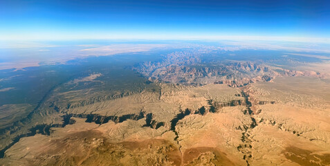 An aerial view of the Grand Canyon, showcasing its immense depth and the vast expanse of the...