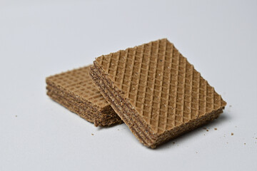 Close up view of two (2) square chocolate wafers isolated on a white background. Stack.