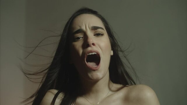 Beautiful young female singing naked in a msensual environment