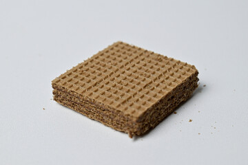Close up view of square chocolate wafer isolated on a white background