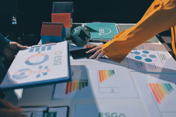 ESG environmental social governance display on laptop on eco-friendly company meeting with business...