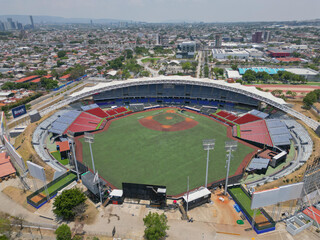 A frontal aerial view showcasing the Charros de Jalisco Stadium in Guadalajara, highlighting its architecture and surrounding areas