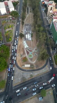 Aerial vertical pan over Lazaro Cardenas avenue in Guadalajara, highlighting the busy avenue and surrounding urban environment