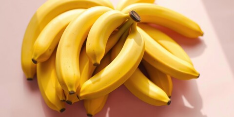 A vibrant cluster of ripe bananas, arranged in a natural and organic pattern, showcasing their golden yellow hues and soft, smooth textures.