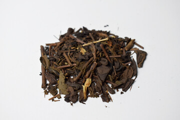 Dried tea leaves pile isolated on a white background, view from above. Close up view.