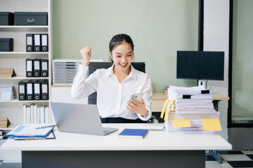 Young beautiful woman using laptop and tablet while sitting at her working place.