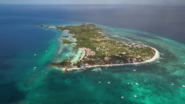 Malapascua island showcasing bounty beach and its vibrant diving spots in cebu philippines , aerial view