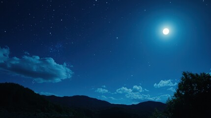 Fototapeta premium Night sky with full moon over mountains and clouds.