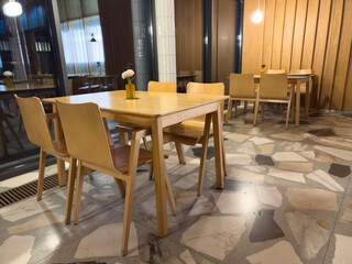 A restaurant with wooden tables and chairs