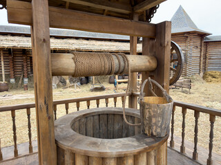A wooden well with a rope hanging from it