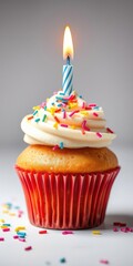 A delicious and colorful cupcake topped with sprinkles and a candle for a Happy Birthday celebration, frosting, birthday