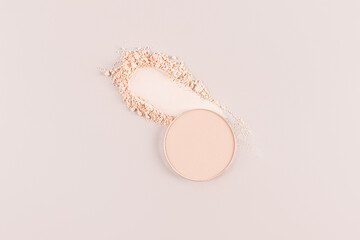 Cosmetic texture of decorative compact powder on a beige background. A block of compact powder in a natural tone and a sample. smear. A copy space