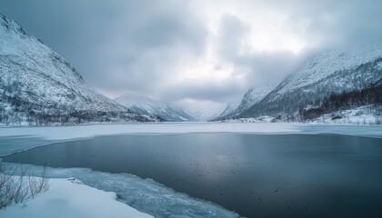 A serene winter landscape featuring a frozen lake surrounded by snow-covered mountains.