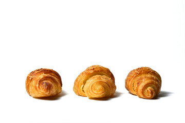 Side view of three Freshly baked mini croissants isolated on white background. Fresh croissant bread isolated.