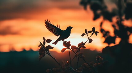 Fototapeta premium Adopt a Rescued Bird Month Silhouette of a bird perched on a branch against vibrant sunset sky
