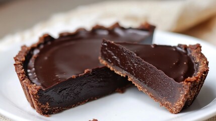 Vegan Gluten-Free Dark Chocolate Ginger Tart Decadent chocolate tart with rich filling and crisp crust on white plate