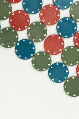 Top view of poker chips on white background. Lot of gambling chips. Board game, playing cards, poker, casino. Copy space, flat lay.
