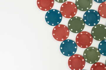 Top view of poker chips on white background. Lot of gambling chips. Board game, playing cards, poker, casino. Copy space, flat lay.