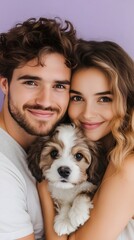 A year-old couple is smiling and embracing their puppy, showcasing joy and love. The purple background adds a vibrant touch, enhancing the warm atmosphere of the moment.