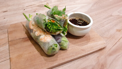 Vietnamese spring roll with shrimp on a wooden tray. Salad spring rolls with prawns. Healthy food concept