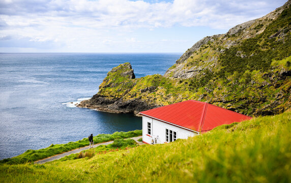 Backpacker walking to Cape Brett Hut at the end of Cape Brett Peninsula. Bay of Islands. New Zealand.