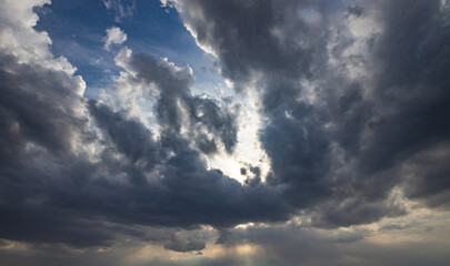 The sky is cloudy and the sun is shining through the clouds