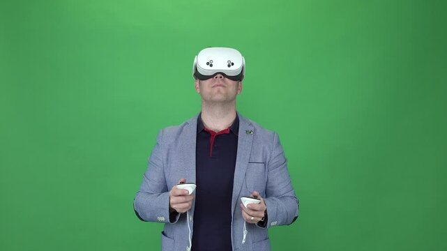 Moving head in virtual reality wiht Meta Quest 3s headset. Green Screen. Young adult business man.