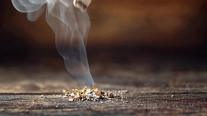 Close-up of a hand extinguishing a cigarette on a rustic wooden surface.  The Video evokes themes of quitting, addiction, and making healthy choices.