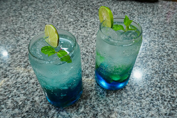 Glass of tasty blue mojito cocktail