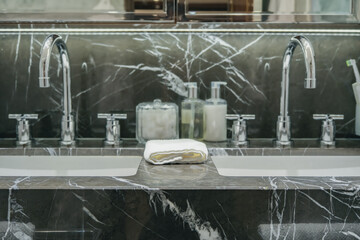 Super deluxe black and white marble bathroom of suite stateroom cabin onboard luxury ocean liner...