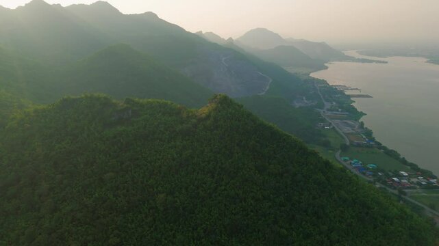Aerial Drone fly Lush Jungle Mountains at Thailand Kanchanaburi River Landscape, Sunset Panoramic of Southeast Asian Rural Village