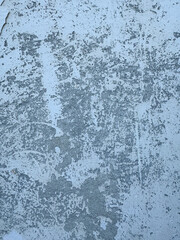 White grey old wall with shabby damaged plaster. Textured plaster wall surface with peeling paint in various shades. Cement and brick background. Wallpaper, backdrop, design