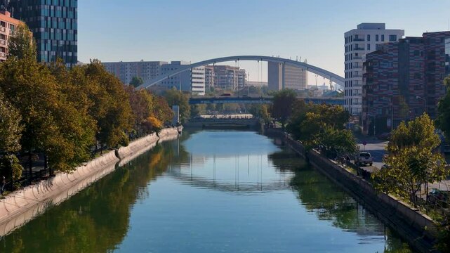 Flying Over Dambovita River in Regie Neighborhood with Basarab Bridge in the Background, Autumn, Bucharest, Romania