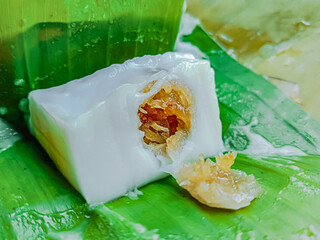 Steamed flour with coconut filling wrapped with banana leaf, Kanom sai sai.