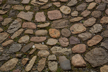 retro old cobblestones of a street which were laid out a bit disorganized