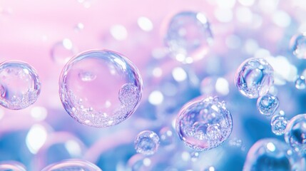 Glossy bubbles in water against pink background.