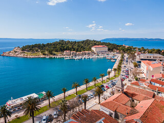 Aerial view of Makarska city center with its vibrant waterfront, yachts, traditional architecture, and the stunning Adriatic Sea coastline