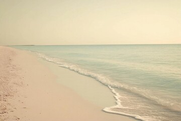 Serene beach scene with gentle waves and soft pastel colors.
