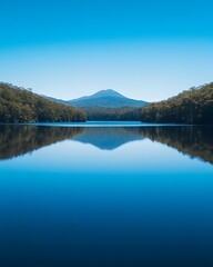 Naklejka premium Verdant Horizon Adventures, Tranquil Lake Under Clear Blue Horizon